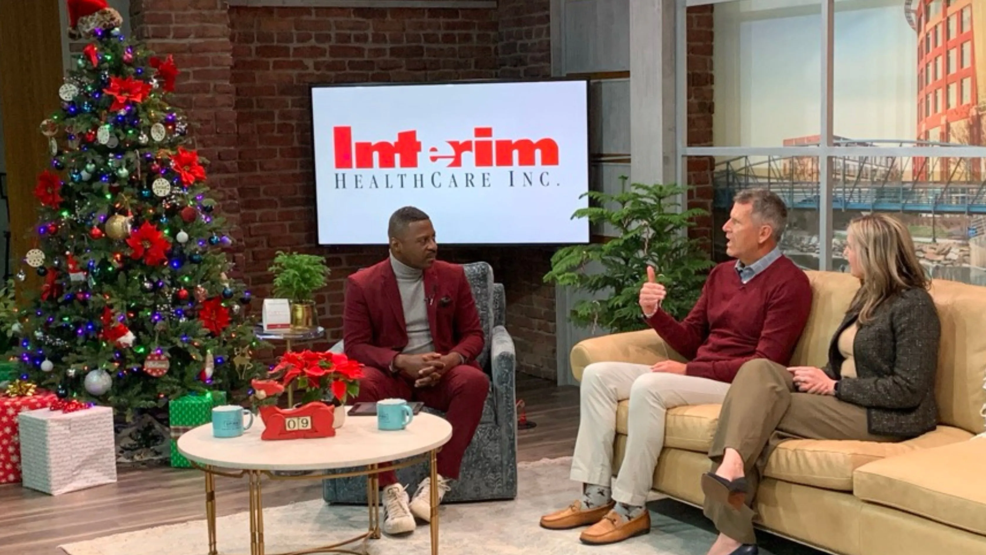 Host and two hospice employees sit in living room set for interview on Your Carolina.