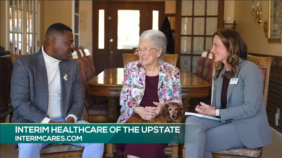 Host and Elizabeth Handford and Interim employee sit to discuss devotional book for Interim Hospice