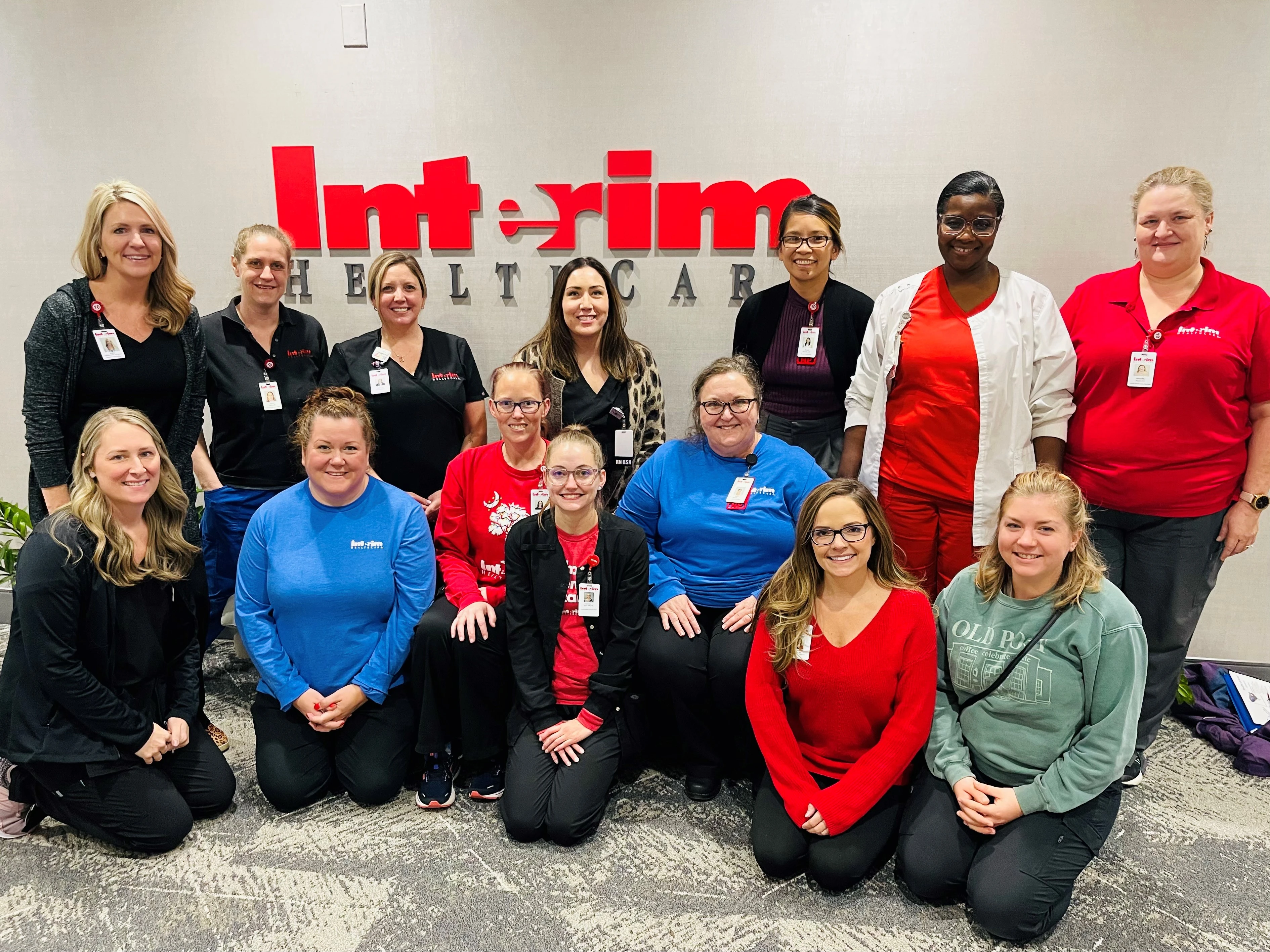 Interim HealthCare's Wound Treatment Associate program nurses smiling in front of Interim sign