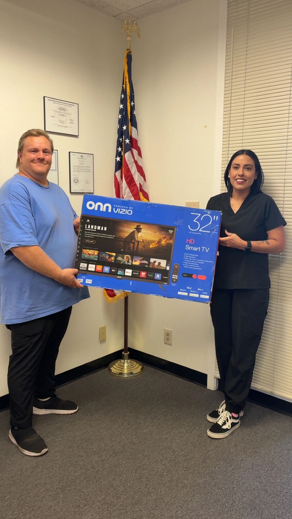 Jonathan receiving flat screen tv gift from Interim Healthcare