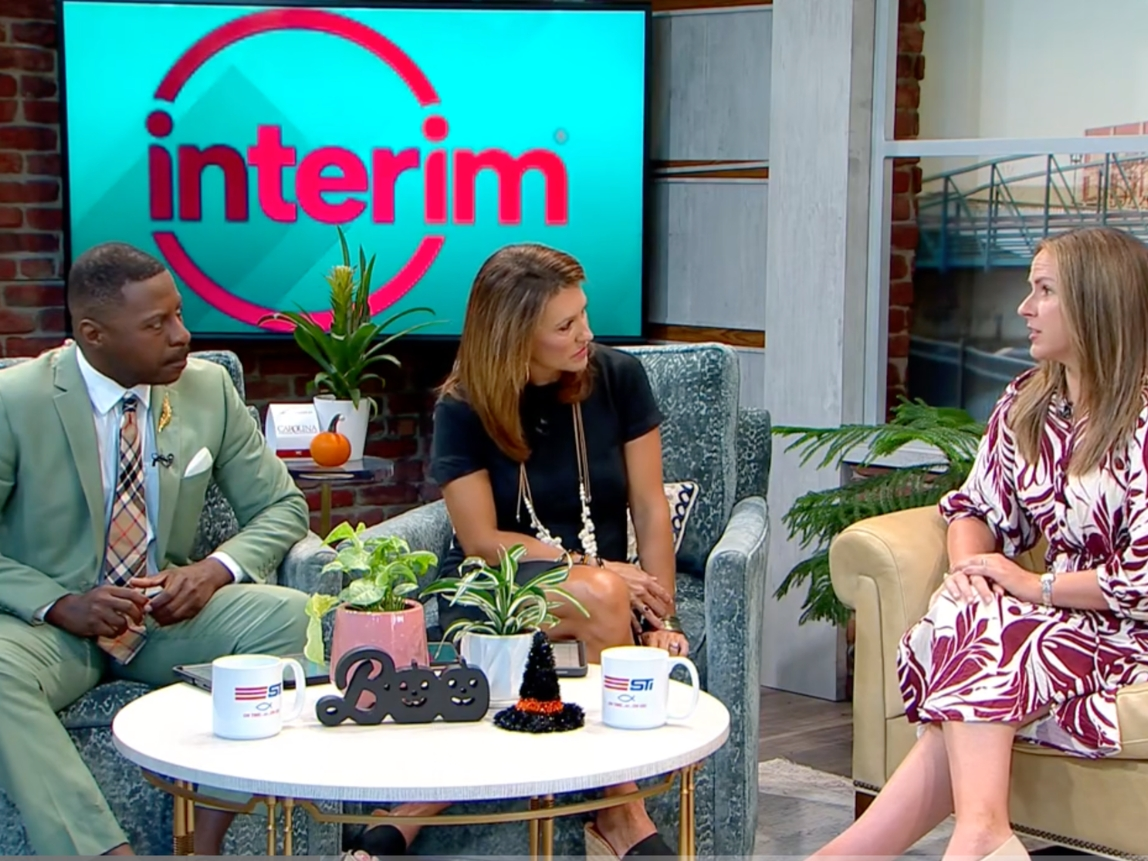 Photo of male and female Your Carolina TV show hosts interviewing female Interim HealthCare employee