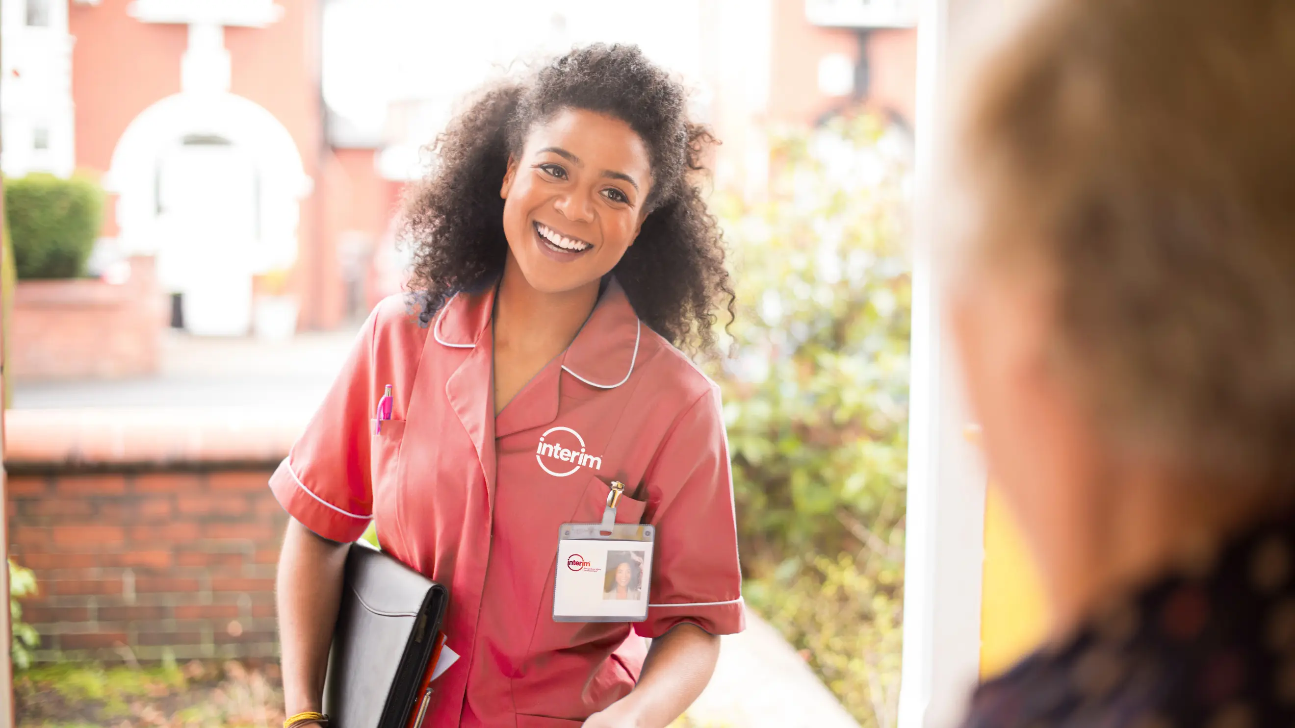Home Health Nurse Visiting Client at Doorway